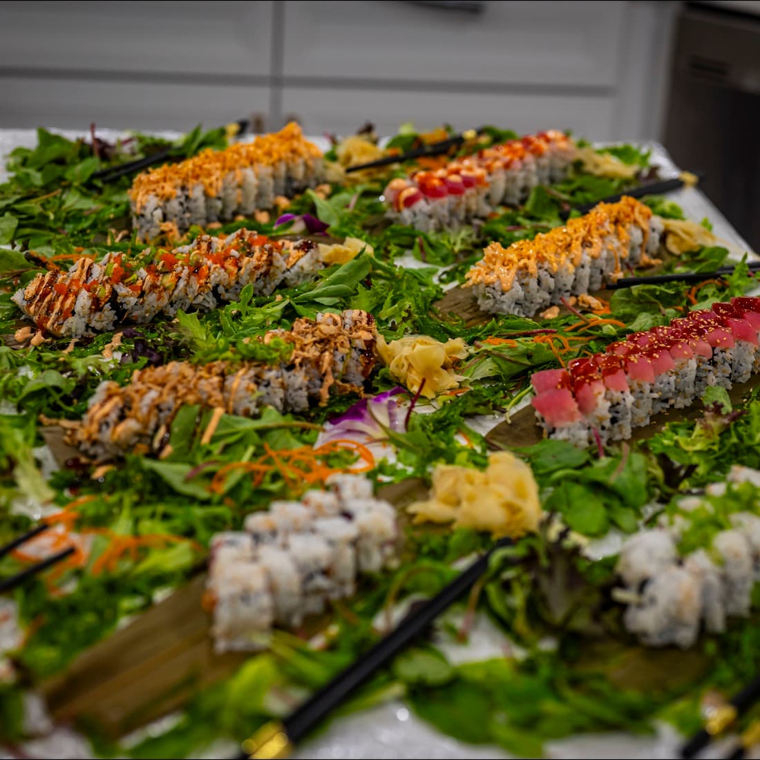 A full platter of specialty sushi rolls prepared for a private event.