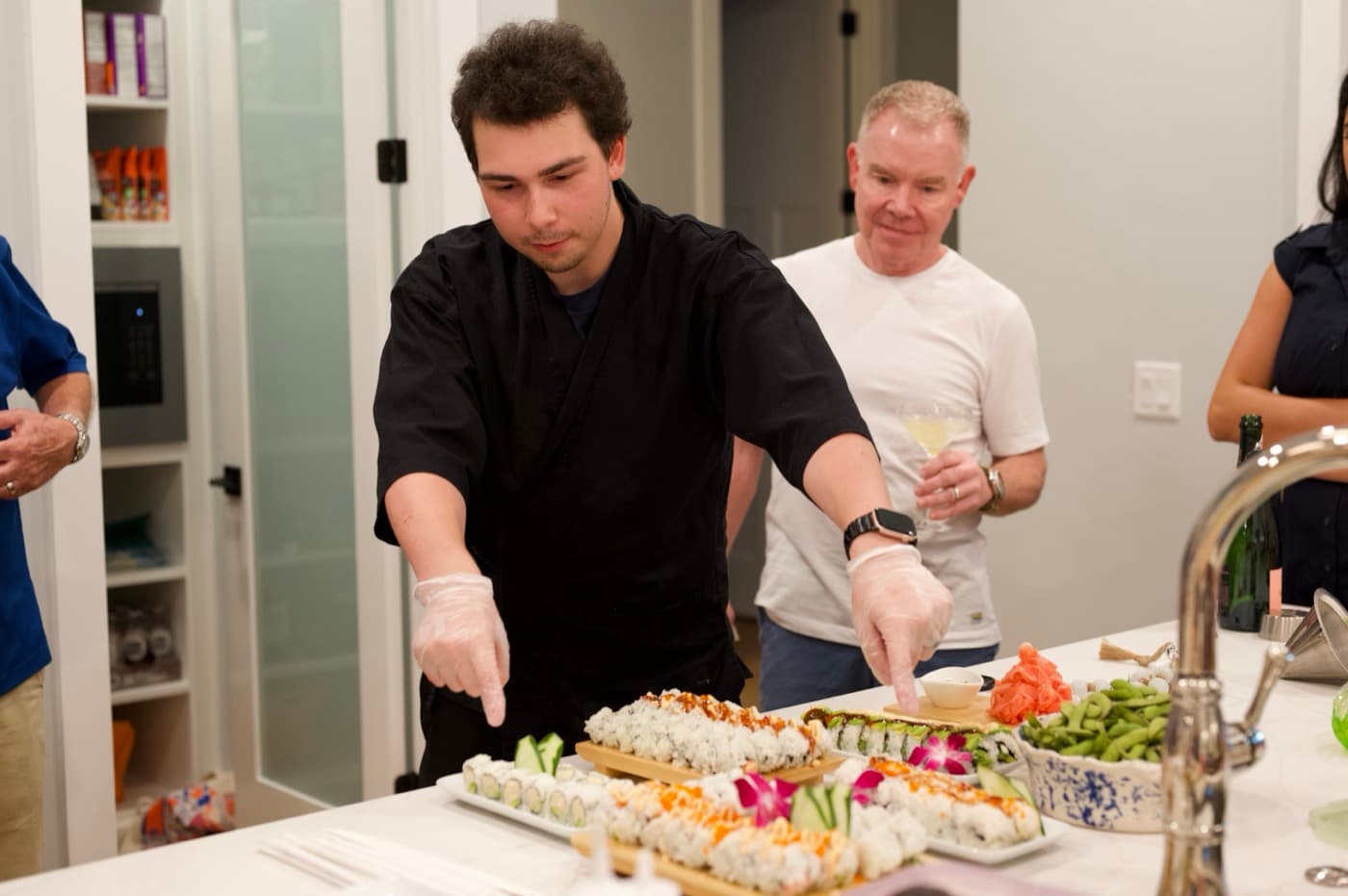 The chef walking guests through the spread at an in-home event.