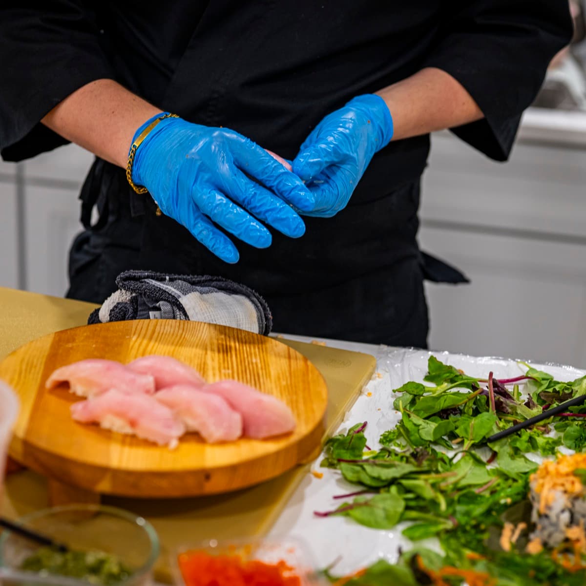 Fresh salmon sashimi cut and plated on a wooden board.